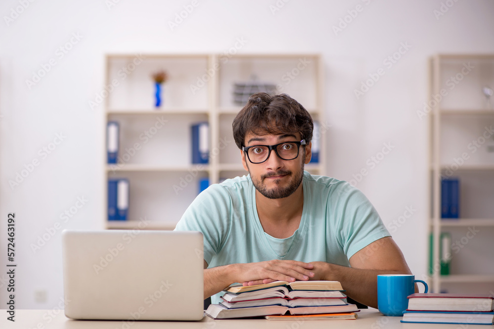 Young male student preparing for exams in the classroom Young male student preparing for exams in the classroom