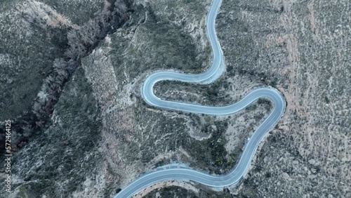 Aerial Drone view of dry valley and mountains at Gorafe, Desierto de los Coloraos in Blue sky, Sierra Nevada, Granada, Spain. Spanish desert canyon with vegetation, in Andalusia. Flying over mountain