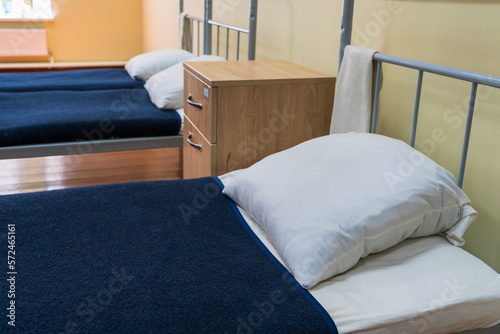The made-up bed of a soldier in the barracks. Background, selective focus