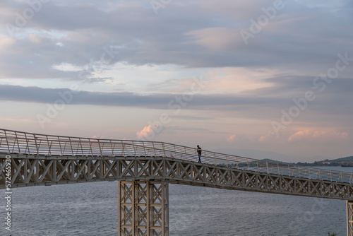 View of Avci ramadan park from aliaga izmir, colorful lighthouse and iron bridge shoted in different times and light conditions with landscape concept idea photo