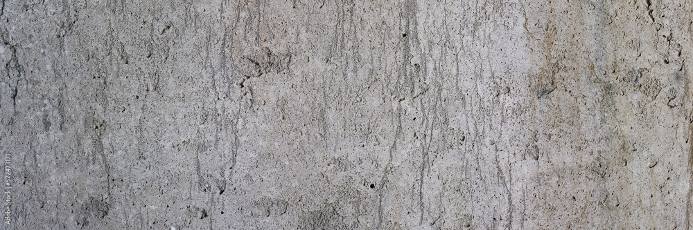 Texture of old concrete wall. Rough grey concrete surface. Wide panoramic background for design. Texture of old concrete wall. Rough grey concrete surface. Wide panoramic background for design.