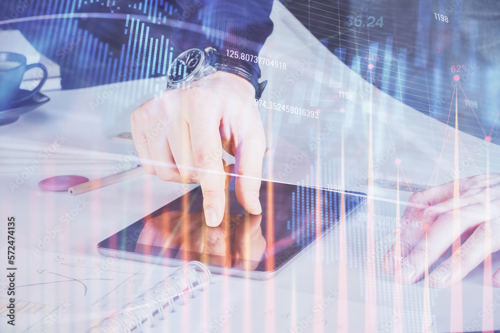 Double exposure of man's hands holding and using a digital device and forex graph drawing. Financial market concept. Double exposure of man's hands holding and using a digital device and forex graph drawing. Financial market concept.