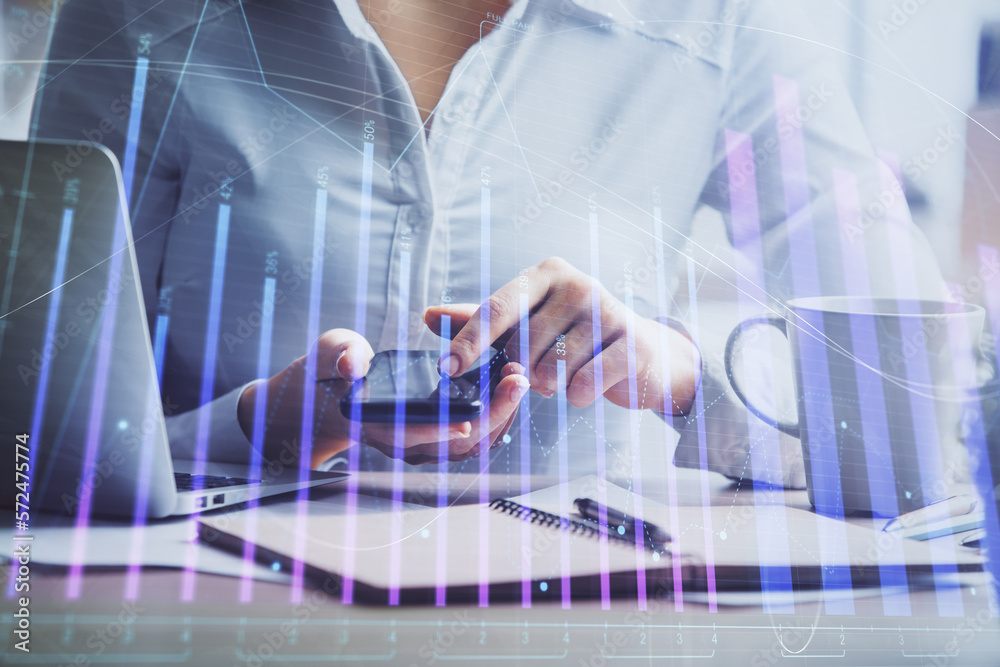 Double exposure of forex chart sketch hologram and woman holding and using a mobile device. Financial market concept. Double exposure of forex chart sketch hologram and woman holding and using a mobile device. Financial market concept.