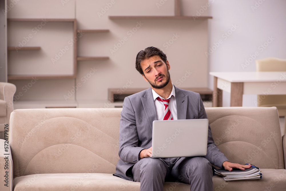 Young male employee working from home during pandemic Young male employee working from home during pandemic