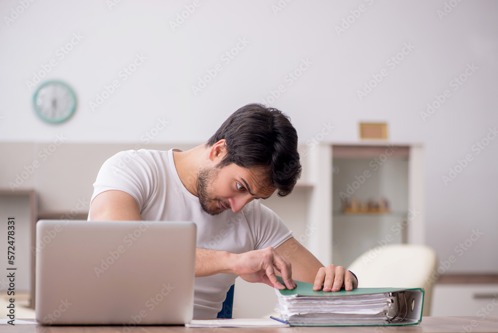 Young male employee working from home during pandemic Young male employee working from home during pandemic