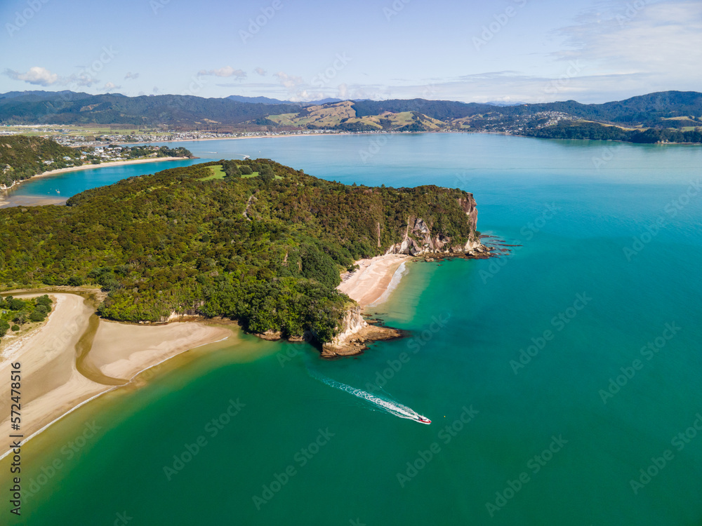 Boat Tour along the Coromandel Peninsula in New Zealand. Summer day viewing along the coast line at low tide.