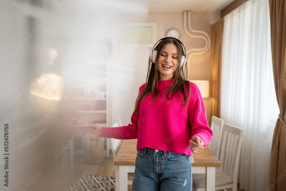 One young woman caucasian dance with headphones at home listen music One young woman caucasian dance with headphones at home listen music