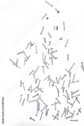 Screwdriver Nail fly floating in mid air. Many group screw nails short long metal fall as construction tools. Black background isolated. New Screwdriver Nail fall down unbox steel hardware work