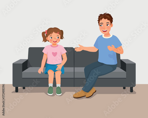 Young father talking to his daughter sitting on sofa giving advises encouragement and support 