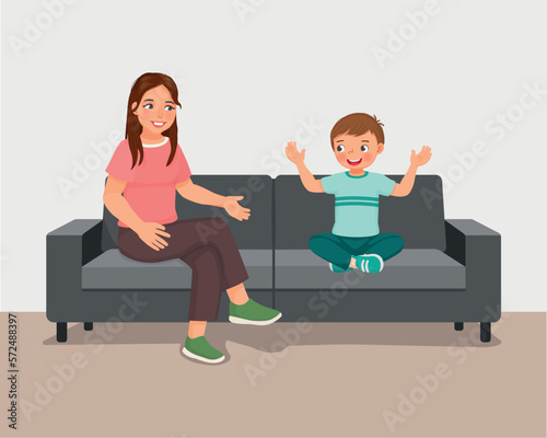 Young mother talking to her son sitting on sofa giving advises encouragement and support 