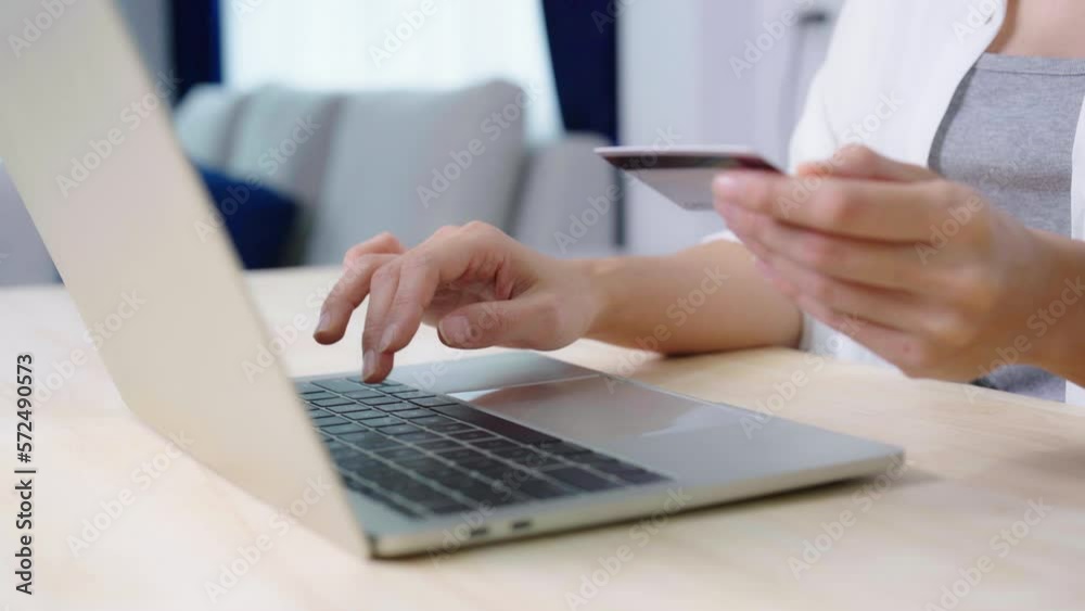 Young asian woman makes online banking payments through the internet from bank card on computer laptop. Shopping online on notebook with credit card Young asian woman makes online banking payments through the internet from bank card on computer laptop. Shopping online on notebook with credit card