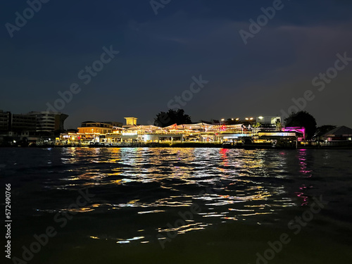 Bangkok city, night view from Chao Phraya River to the Tha Maharaj shopping mall and restaurant on the embankment. Capital of Thailand. Bangkok's historic Old Town. Krung Thep Maha Nakhon photo