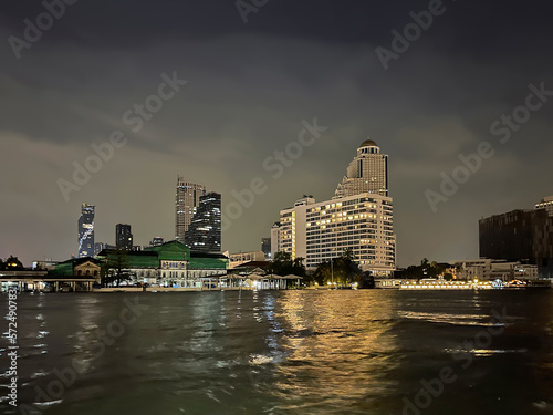 City skyline at night. View from the Chao Phraya River to the Mandarin Oriental Hotel and lebua at State Tower  Lebua Hotel   Sky Bar. Bangkok  Thailand. Beautiful cityscape. Reflection of lights.