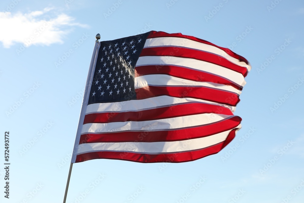 Obraz premium American flag fluttering outdoors on sunny day