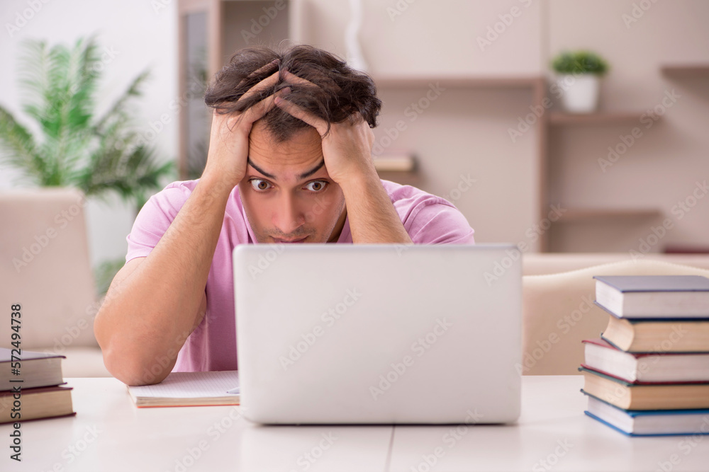 Young male student preparing for exams at home Young male student preparing for exams at home