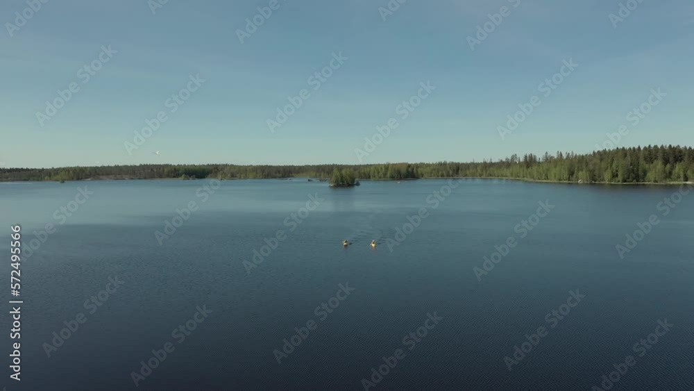 Two kayaks in lake during summertime. Circle movement. Two kayaks in lake during summertime. Circle movement.