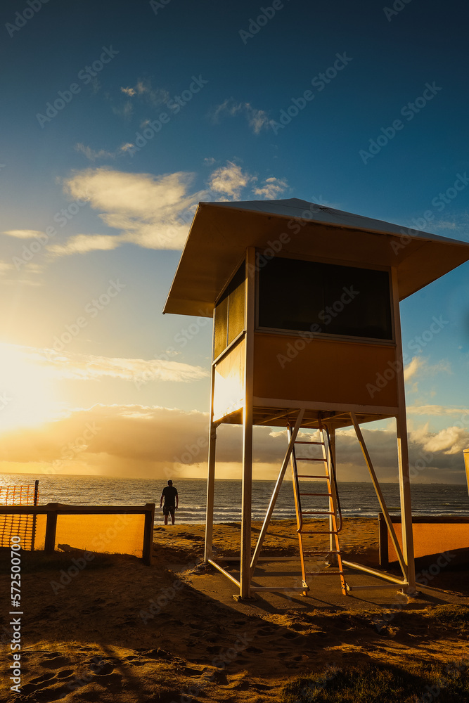 Lifeguard tower by the beach in golden morning light at sunrise Lifeguard tower by the beach in golden morning light at sunrise