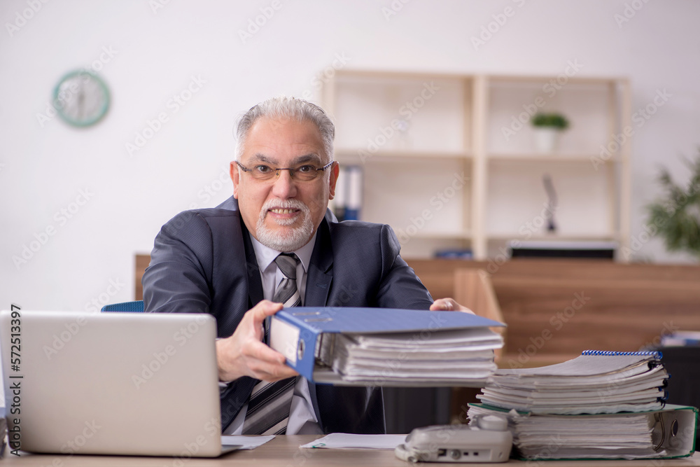 Old male boss employee working in the office