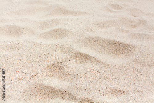 White sand texture close up background, wavy sandy pattern, natural dry sand grains backdrop, clean beige rippled sand surface top view, light yellow desert dune, summer tropical sea beach, copy space © Vera NewSib