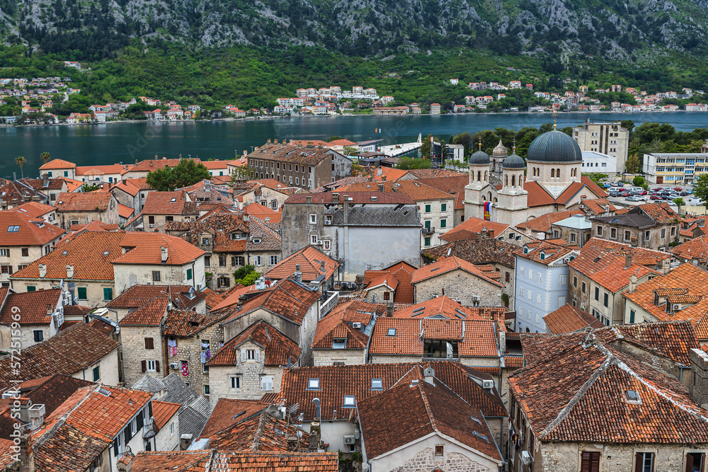 Obraz premium Rooftop view of Kotor historical center and beautiful bay surrounded by rocky mountains in Montnegro