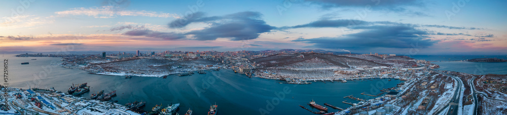 Winter sunset aerial panorama of Vladivostok city surrounded by Sea of Japan, Far East of Russia