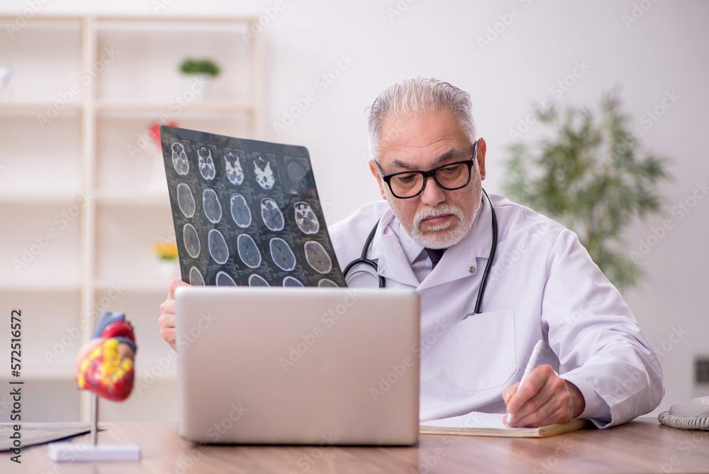 Old male doctor radiologist working in the clinic Old male doctor radiologist working in the clinic