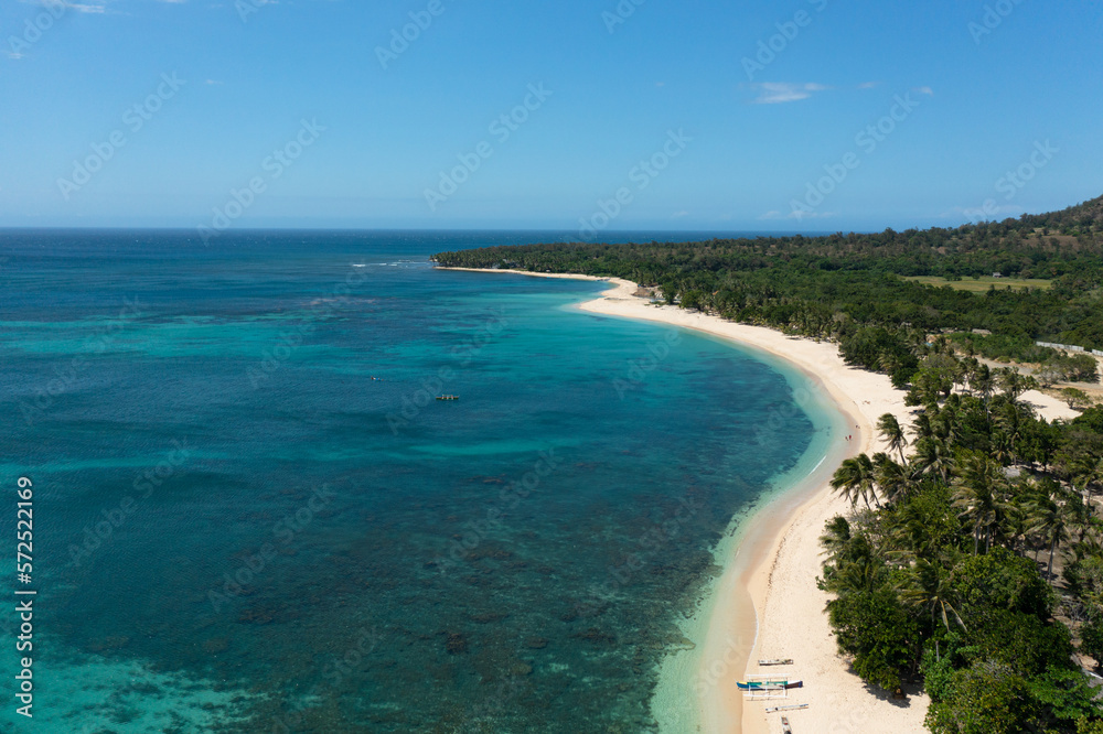 Seascape with tropical sandy beach and blue ocean. Pagudpud, Ilocos Norte Philippines