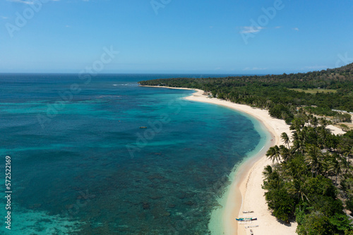 Seascape with tropical sandy beach and blue ocean. Pagudpud, Ilocos Norte Philippines