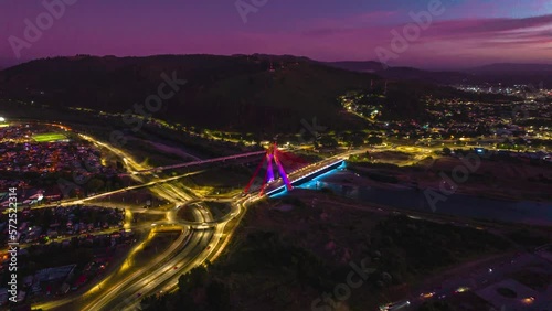 Aerial Hyperlapse Above Temuco City at Sunset Nighttime Chile, Roundabout, Cable Bridge above Cautin River, Hill Houses at Andean Valley Araucaria Region photo