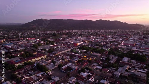 Aerial Drone Above Temuco, Chile, Sunrise Time, Hills, Houses and Town Streets, Pink Skyline Horizon, Cautin Province photo