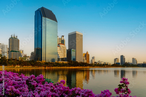 Canvas Print Bangkok, Thailand, Ratchada Lake located in Benjakitty Park with flowers in the foreground and modern high-rise buildings in the background in central Bangkok, Thailand