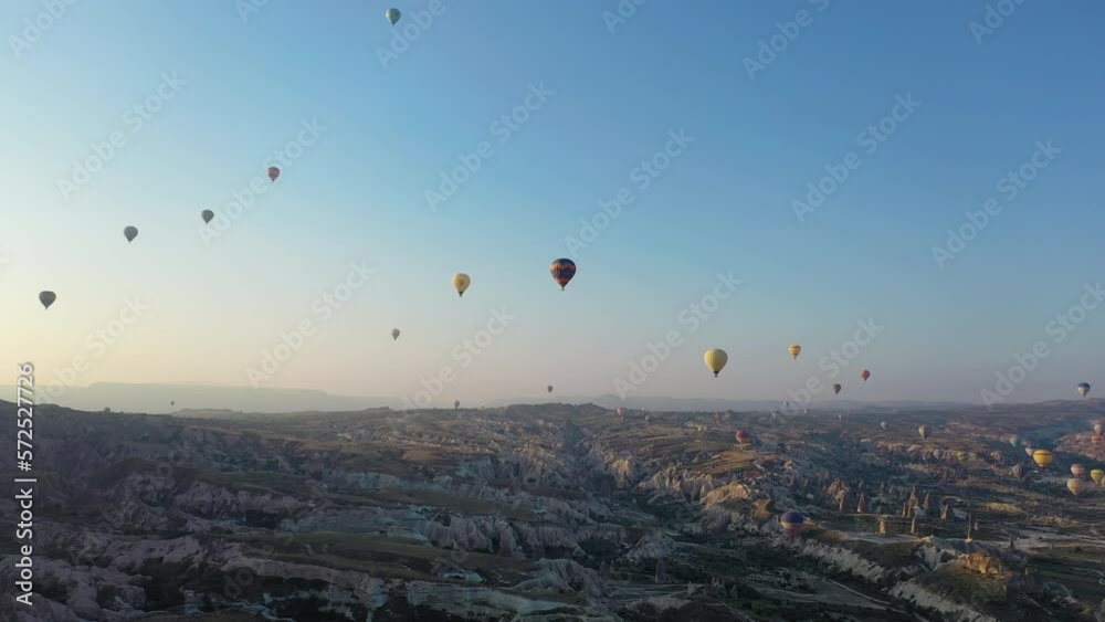 Epic cinematic drone shot flying and following the hot air balloons floating over Cappadocia, Turkey Epic cinematic drone shot flying and following the hot air balloons floating over Cappadocia, Turkey