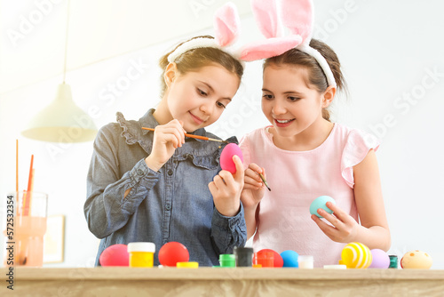Cute twin girls painting Ea...