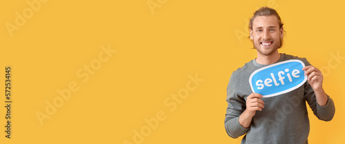 Happy male blogger holding ...