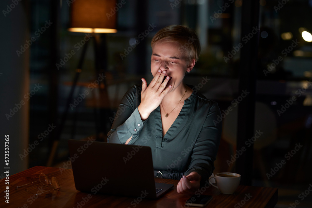 Tired, late and woman working on a laptop, yawning and feeling burnout in a dark office. Sleepy, overworked and employee with fatigue doing overtime for a project deadline at night on a computer Tired, late and woman working on a laptop, yawning and feeling burnout in a dark office. Sleepy, overworked and employee with fatigue doing overtime for a project deadline at night on a computer