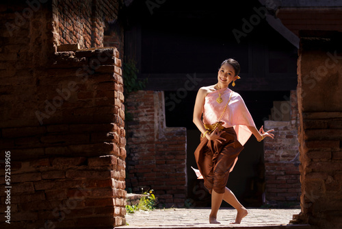 A beautiful lady  in Thai traditional costume shows traditional basic Thai dance.