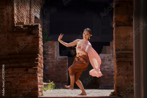 A beautiful lady  in Thai traditional costume shows traditional basic Thai dance.