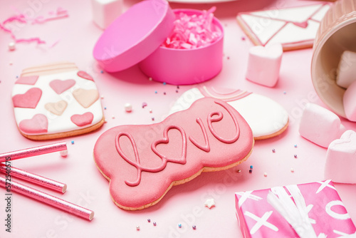 Tasty cookies for Valentine's Day celebration on pink background