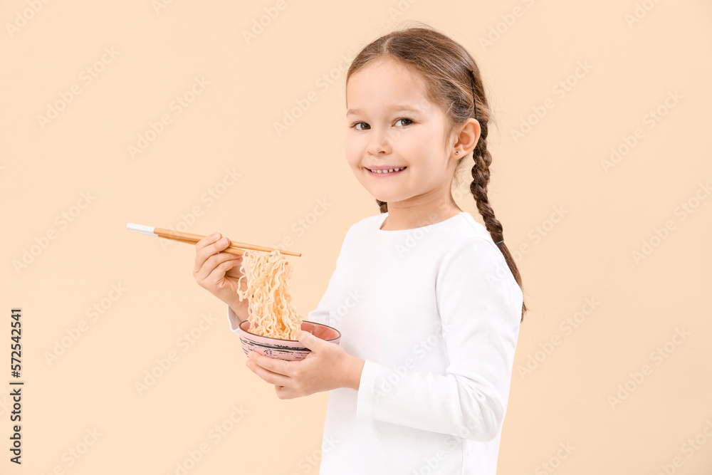 Little girl with bowl of Chinese noodles on beige background Little girl with bowl of Chinese noodles on beige background
