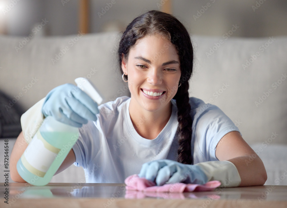 Cleaning, nanny and woman spray a table surface to remove bacteria and dirt for hygiene in a home, house or apartment. Young, female and cleaner with detergent or soup to wipe desk clean Cleaning, nanny and woman spray a table surface to remove bacteria and dirt for hygiene in a home, house or apartment. Young, female and cleaner with detergent or soup to wipe desk clean