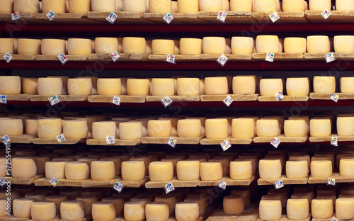 Many rows of cheese in the cellar with production dates