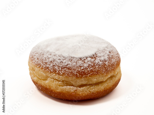 Freshly baked and dusted with powdered sugar German donuts. Donut berliner or krapfen on white background.