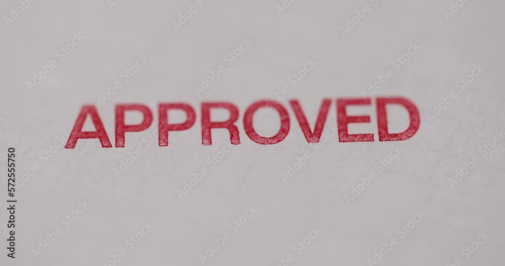 Person to puts stamp seal approved stamp closeup Person to puts stamp seal approved stamp closeup