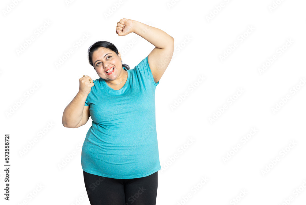 Cheerful overweight indian woman standing isolated over white studio background. Happy fat asian female model, Copy space. Closeup.