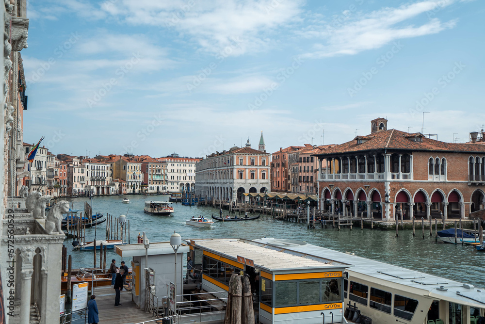 Grand Canal, gondola, and local transportation with blue sky background in Venice, Italy