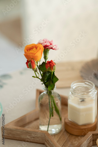Orange rose in a small vase
