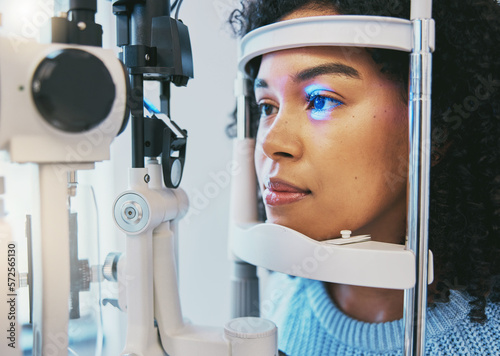 Ophthalmology, medical and eye exam with black woman and consulting for vision, healthcare and glaucoma check. Laser, light and innovation with face of patient and machine for scanning and optometry photo
