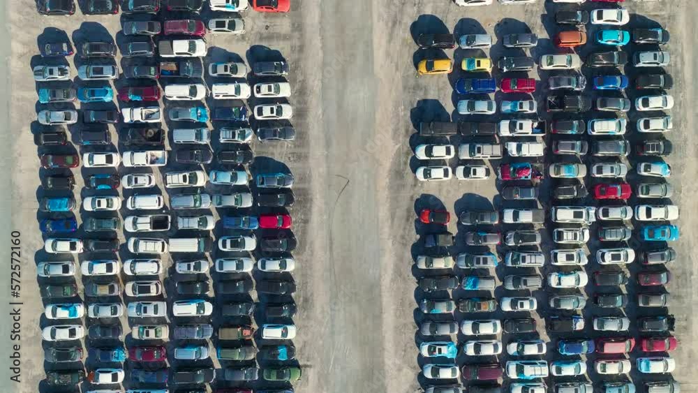 View from above of big parking lot with parked used cars after accident ready for sale. Auction reseller company selling secondhand broken vehicles for repair