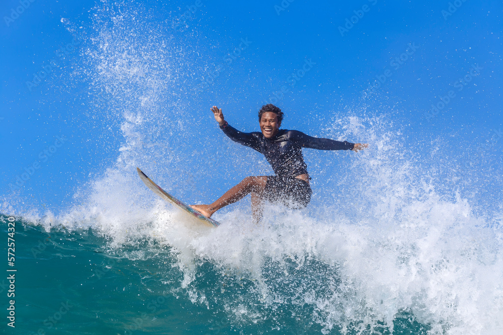 Surfer riding wave, Kuta, Lombok, Indonesia Surfer riding wave, Kuta, Lombok, Indonesia