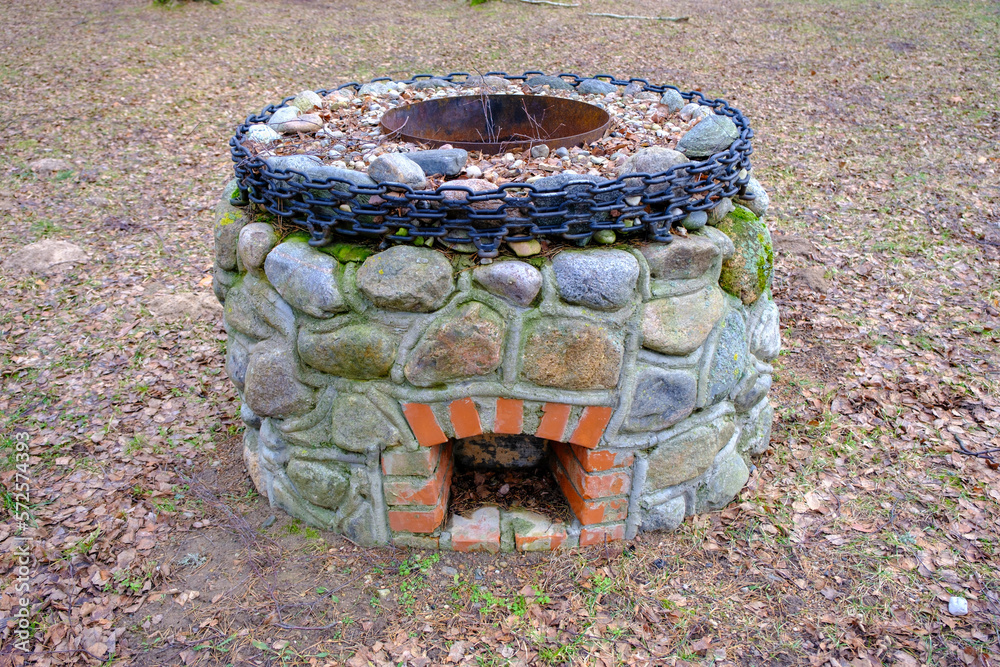 Obraz premium idyllic outdoor barbecue area - built with flat stones campfire place. For public use.